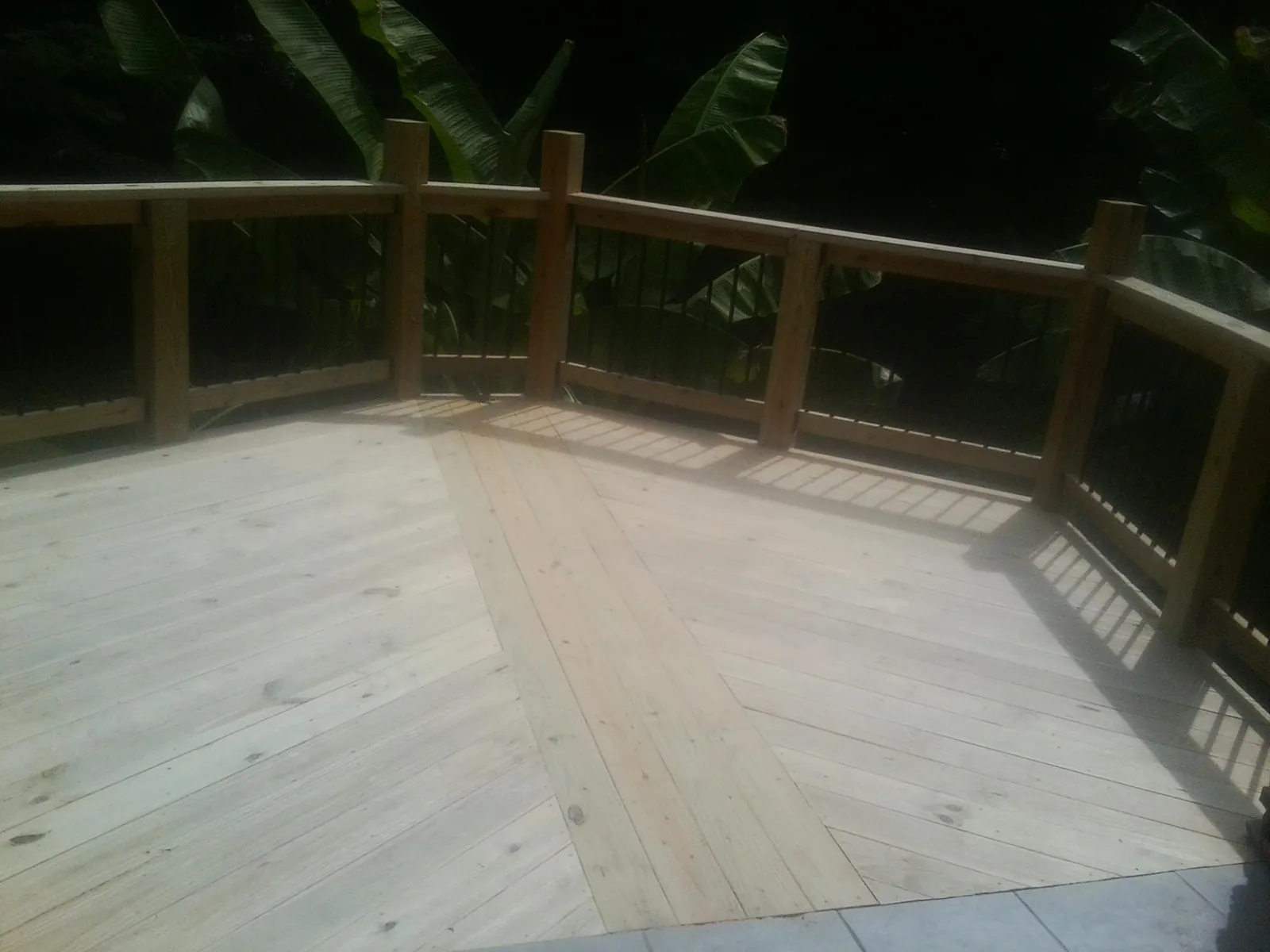 New wood deck and railing built off the back of a home in Lake Katrine