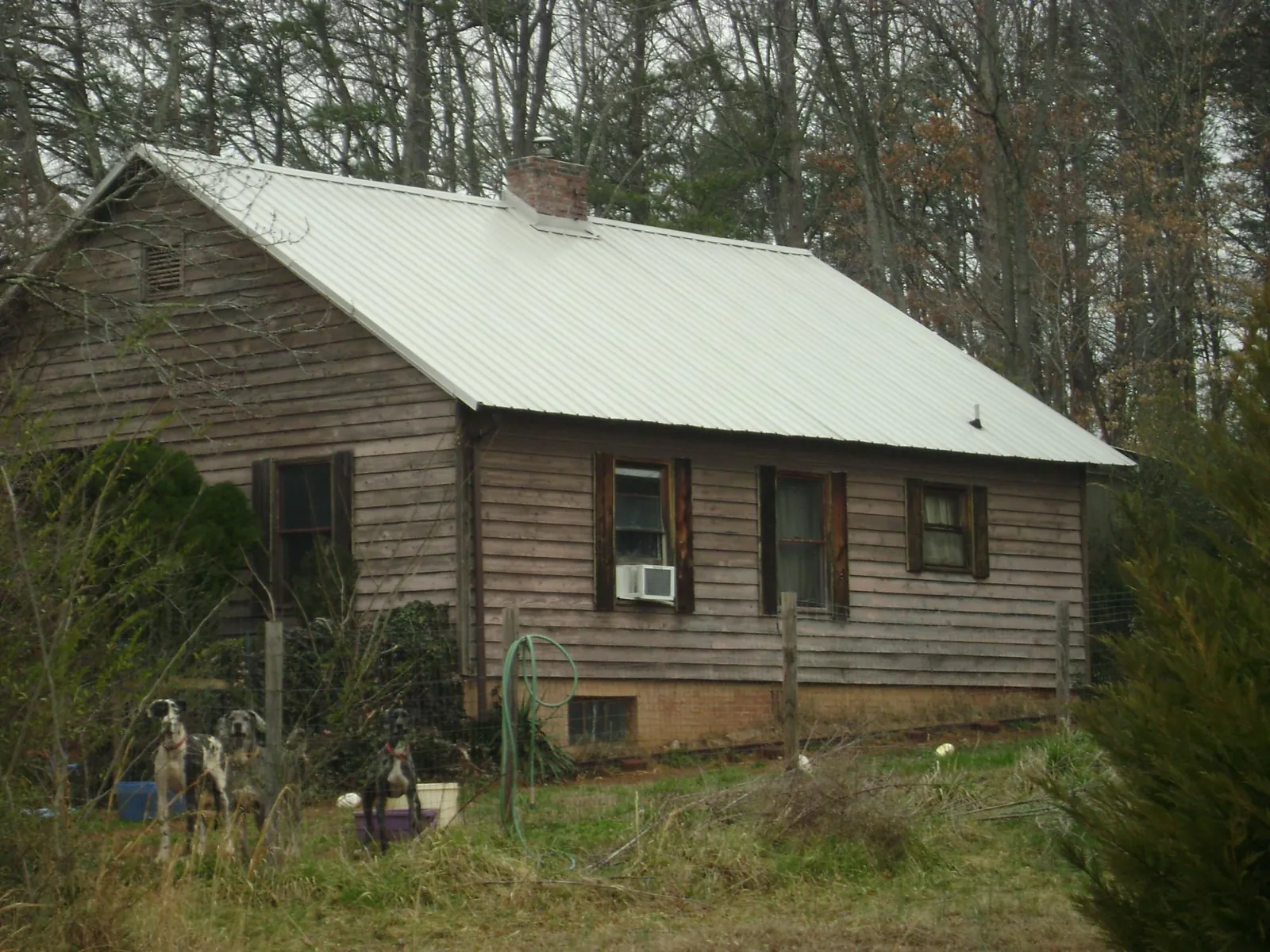 White metal roof on an old wood sided farmhouse, from a Metal Roof Installation job in Lake Katrine